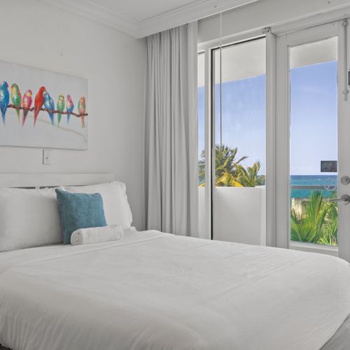 Cozy and well-decorated sleeping area with two comfortable beds. Charming artwork and soft lighting create a serene ambiance.