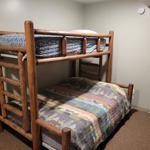 Bedroom #3 (first floor):  family-friendly first floor bedroom with a twin-on-queen bunk bed, closet, and dresser.