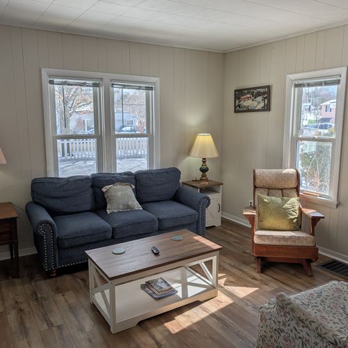LIVING ROOM:  Very comfy and cozy living room with 2 sofas, a futon, a rocking chair, coffee table, new flooring, and new live streaming television.