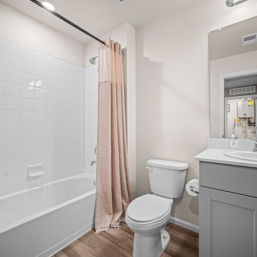 Unwind in the secondary bathroom with a soothing bath-shower combo.