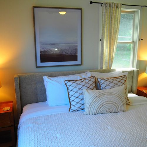 Bedroom #1:  features a king-size bed, nightstands, lamps, ceiling fan, chair, desk, and a closet.