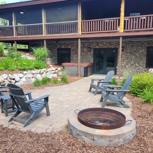 Exterior:  photo of the backyard patio, including the bonfire ring and hot tub / spa.