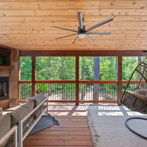 The private covered balcony has luxury seating and a fireplace.