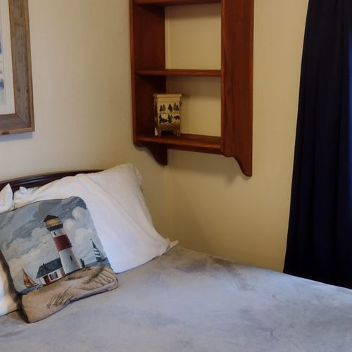 Bedroom #1:  features a full-size bed, nightstand, lamp, dresser. And closet.