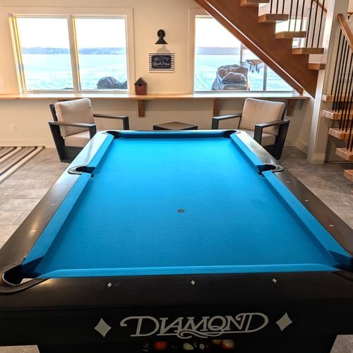 GAME ROOM (LOWER LEVEL):  The home has an incredible game room on the lower level with a championship pool table and large screen television.