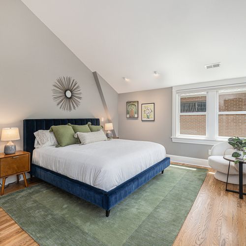 Bright and airy master bedroom with luxurious bedding.