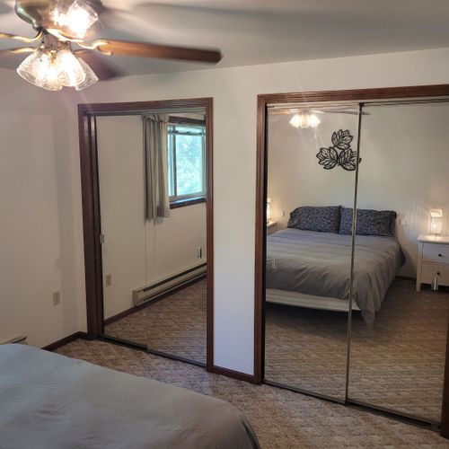 Bedroom #1:  features a sleep number adjustable queen-size bed, closet, ceiling fan, nightstands, and lamps.
