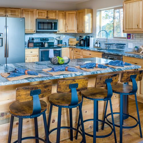 The upgraded kitchen features an expanded granite island with seating for 4. The  kitchen is fitted with essential cooking tools and stainless steel appliances.