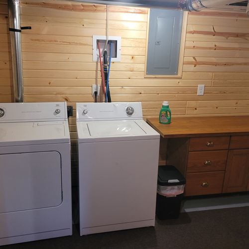 Laundry room:  there is a large laundry room in the basement that includes a washer, dryer, folding area, iron, and ironing board.