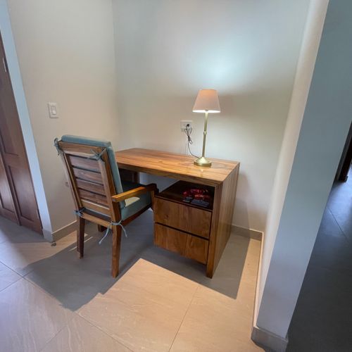 Enjoy the new wooden desk and chair at the living room.