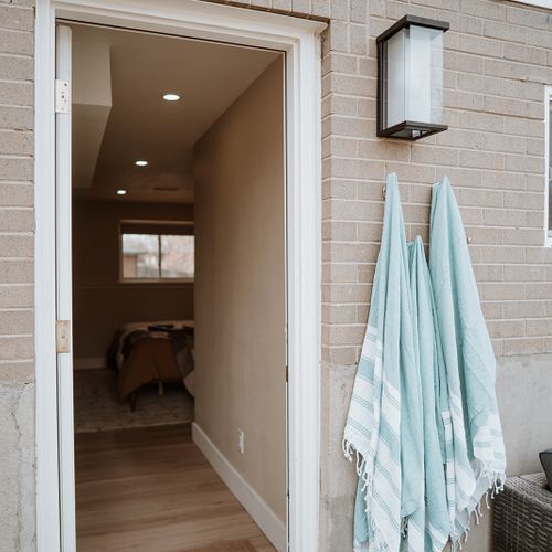 Out-door hot-tub access from the mezzanine king bedroom, equipped with towel racks and hooks for ease.