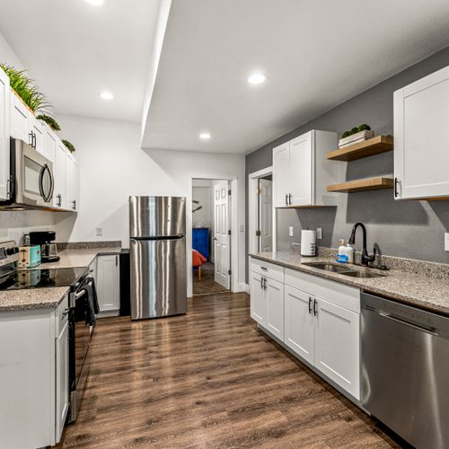 Our complete kitchen setup includes a full-size fridge, oven, stovetop, microwave, and dishwasher.
