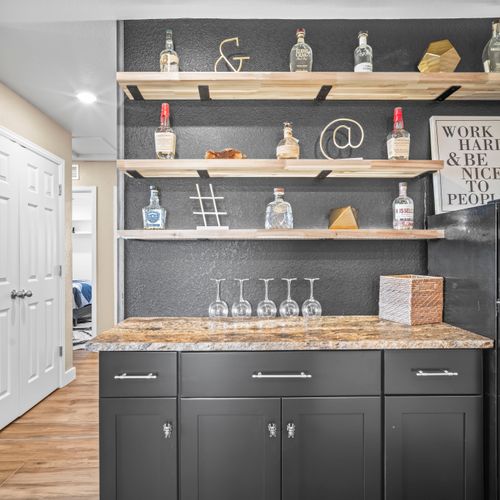 Stylish bar area stocked with glassware, ideal for evening cocktails or celebrations.