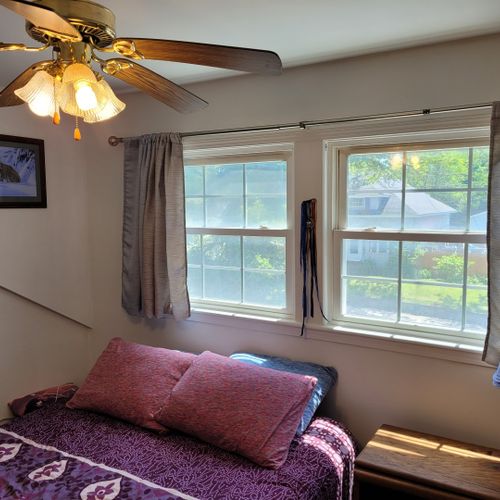 Bedroom #1 ( second floor):  large master bedroom with a queen-size bed, closet, vanity, ceiling fan, pedestal fan, and nightstand.