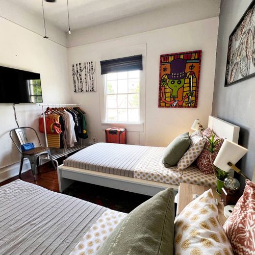 Second bedroom w/ two twin beds & colorful accents for a fun, relaxed stay.