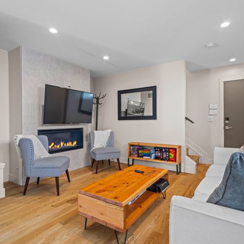 Relax and play in the cozy living room with tv, fireplace, and board games.