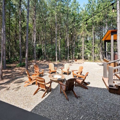 Fire pit with Adirondack chairs.