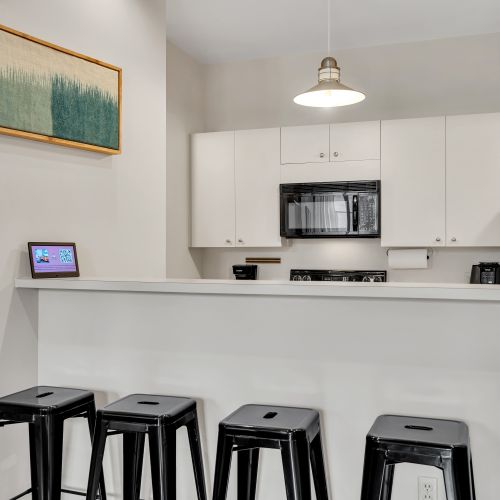 Bright, clean kitchen w/ bar seating for casual meals or morning coffee.