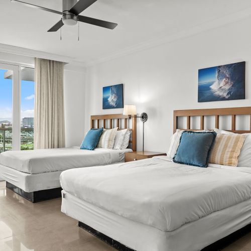 Unwind in comfort with two plush beds, entertainment, and a table, all overlooking the lagoon.