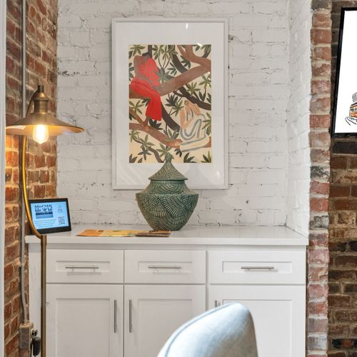Cozy corner with local art and exposed brick—bringing New Orleans charm right into your stay.