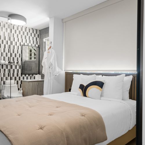 Escape to this tranquil haven featuring a queen-sized bed and a cozy bathroom