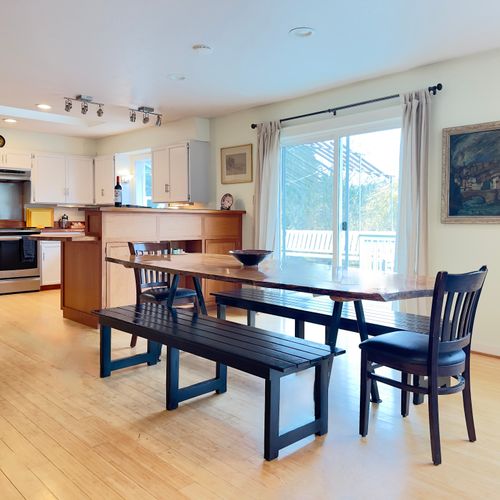 A welcoming dining space made for together time: gather around the table for home-cooked meals, game nights, or lingering conversations, with natural light and easy access to the deck just steps away.
