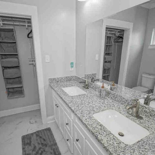 Bright bathroom w/ sink & ample counter space for a comfortable morning routine.