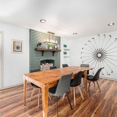 - dine in style with a reclaimed wood table and striking golf themed wall feature
- faux brick fireplace nook and modern lighting set a warm, creative atmosphere
- patio access brings fresh air and outdoor charm right to your mealtime moments