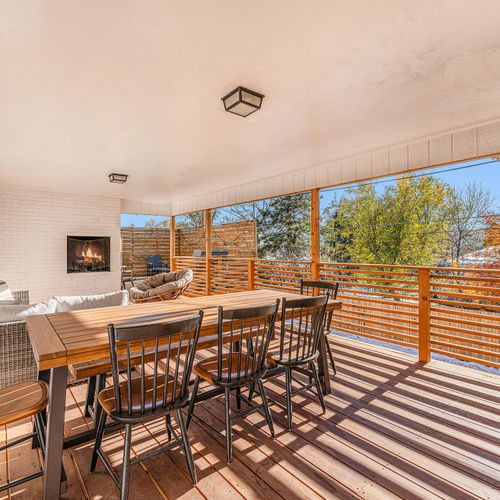 Enjoy al fresco dining with a spacious seating area for 8 on the covered deck, perfect for meals with a view.