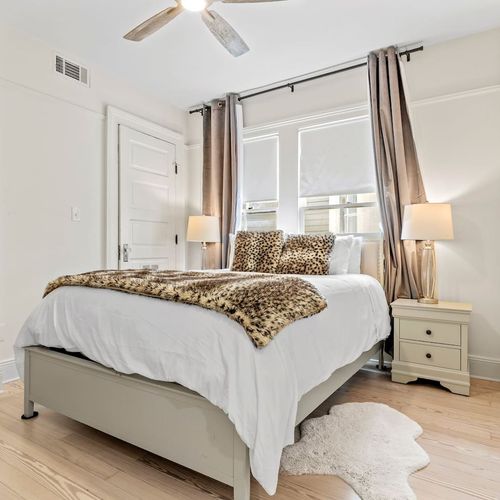 Airy bedroom w/ warm natural light, bold bedding & closet space included.