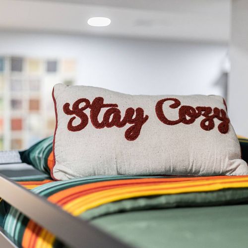 - add a little warmth to your stay with this playful “stay cozy” pillow touch
- bright stripes and comfy bedding make this bunk space cheerful and inviting
- perfect nook for kids or the young at heart to relax and recharge