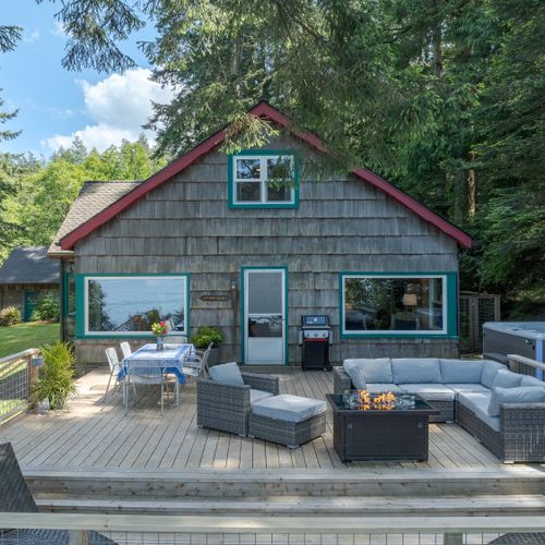 Outdoor living with a spa, firepit and lounge area, infinity deck and dining.