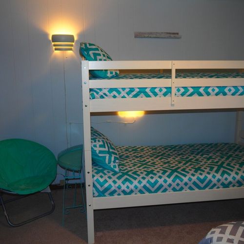 Bedroom #2:  features a full-size bed, bunk bed (i. E. 2 single beds on top of each other), ceiling fan, dresser, mirror, and closet.