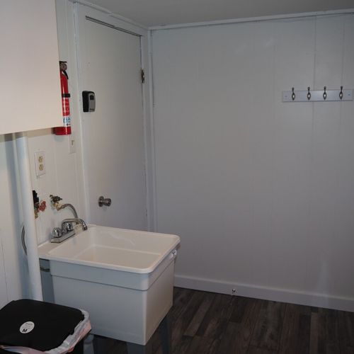 Laundry room:  main floor laundry room with washer, dryer, and sink.