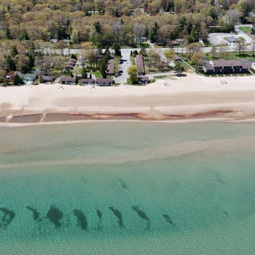 Overall:  an aerial view of the property, the private beach, and lake huron