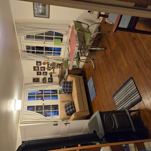 Living room:  the cabin has a cute little living room with a loveseat, dining table, and streaming television.