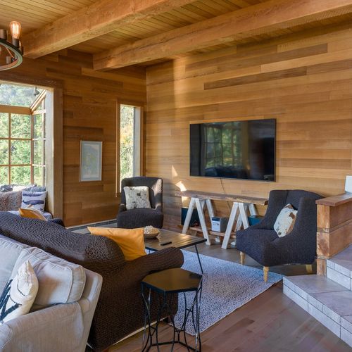 Living room seating with fireplace, and shelf of books and games