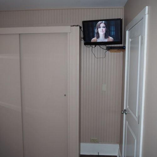 Bedroom #1:  features a queen-size bed, nightstand, lamp, dresser, mirror, closet, and television.