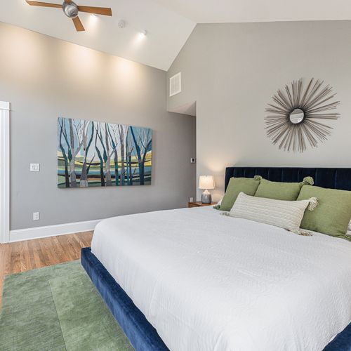 Bright and airy master bedroom with luxurious bedding.