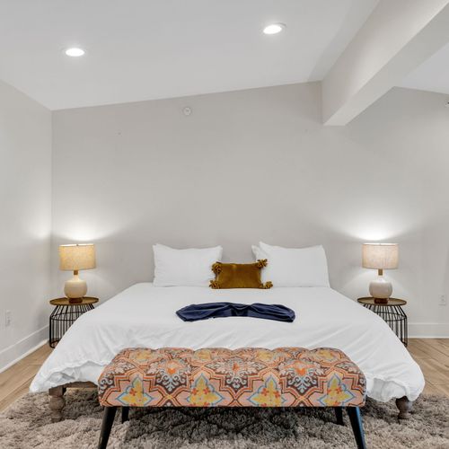Sink into a plush bed with warm lighting and soft textures. This peaceful loft space is made for deep rest and quiet mornings.