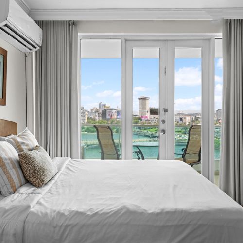 Wake up to stunning lagoon views from your comfortable bed, with direct balcony access.