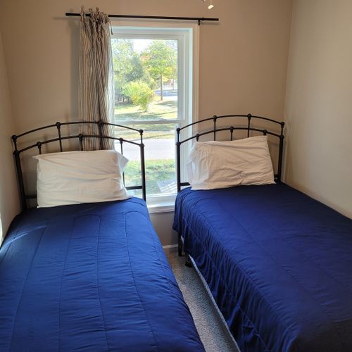 Bedroom #2:   features 2 twin beds, ceiling fan, dresser, closet, and a lamp.