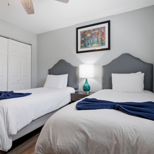 Second bedroom w/ twin beds & soft, calming décor for easy rest.