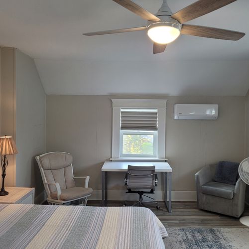 Bedroom #2 (second floor):  huge upstairs bedroom with a king-size bed, nightstands, lamps, 2 dressers, private television with live streaming, mini-split a/c unit, ceiling fan, desk with chair, comfy chairs, and a closet.