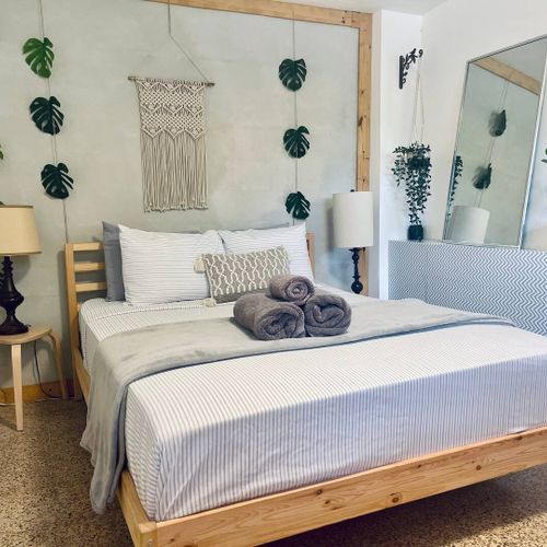 Bedroom: Queen Size Bed, clothing chest, Iron, Smart TV, Wifi, and Air Conditioning.
