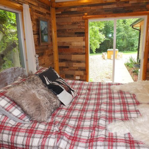 Bedroom #1:  another angle showing the sliding doors that go out to the patio. (the handmade outdoor dining table is visible outdoors. )