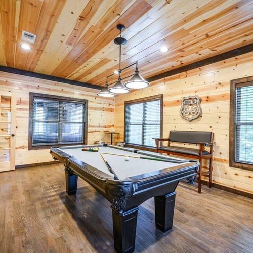 Downstairs off the kitchen you will find a game room with a pool table.