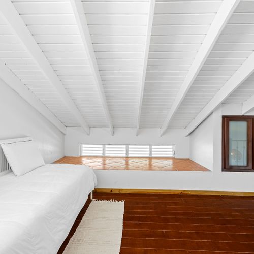 Spacious loft with warm wood floors. A bright, open space perfect for unwinding or stretching out after island adventures.
