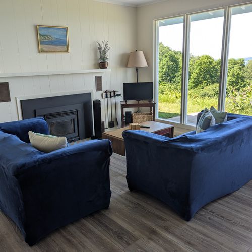 OVERALL:  The home has a comfy living room that includes a wood fireplace and a television.