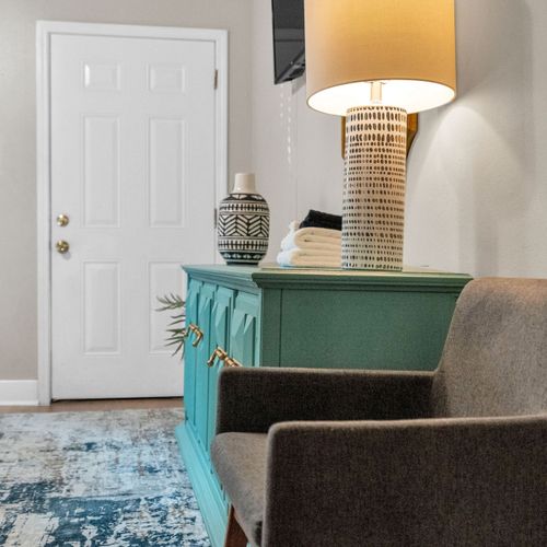 Charming entryway w/ a teal console & local décor to welcome you in style.